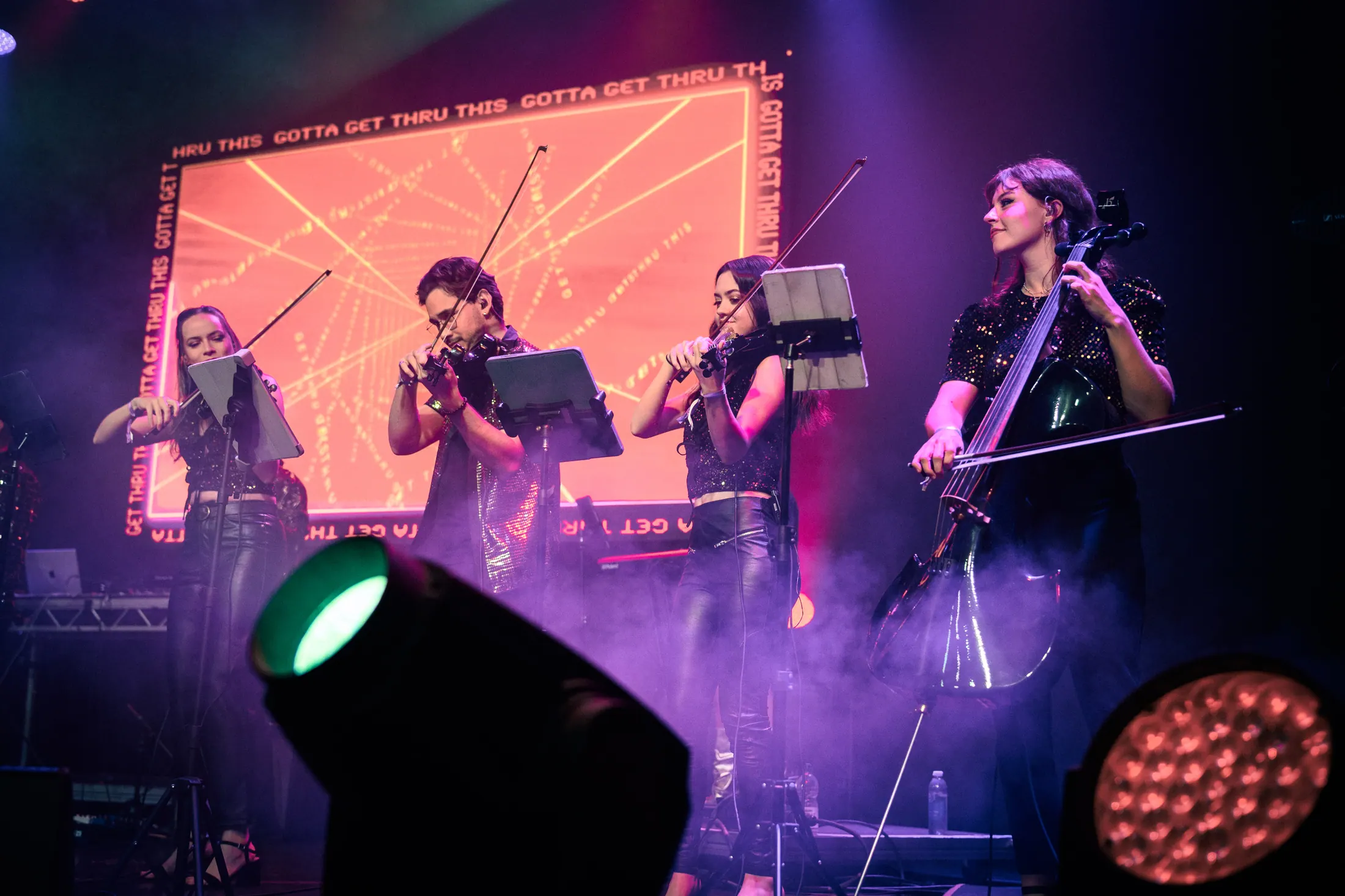 In Symphony string players performing in front of LED content
